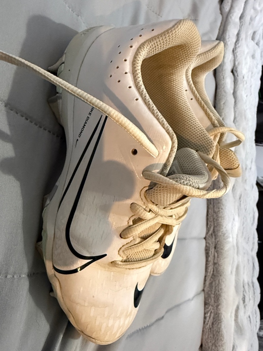 Nike White and Beige Athletic Cleats with Black Swoosh